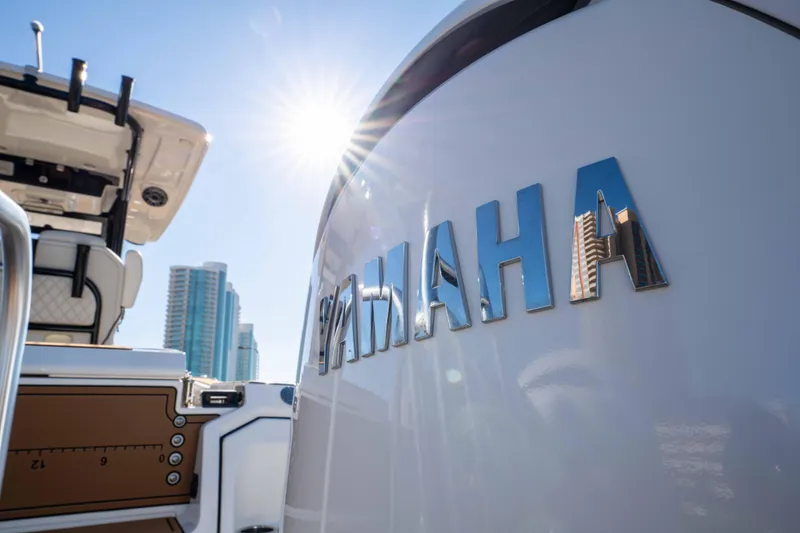 Slide: The Image of 2024 World Cat 260 CC-X boat with Yamaha engine, city skyline in background. - 11