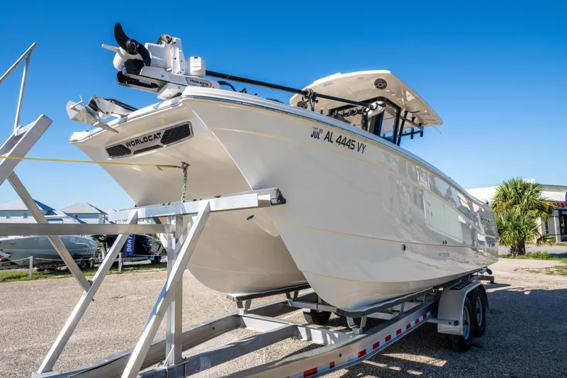 Slide: The Image of 2024 World Cat 260 CC-X boat on trailer, displayed outdoors under clear blue sky. - 14