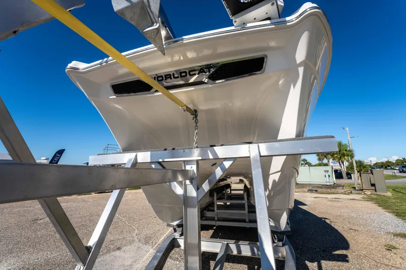 Slide: The Image of 2024 World Cat 260 CC-X boat on trailer, viewed from rear, under clear blue sky. - 15