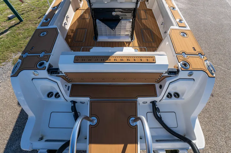 Slide: The Image of 2024 World Cat 260 CC-X boat interior with teak flooring and fishing ruler. - 18