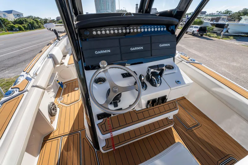 Slide: The Image of 2024 World Cat 260 CC-X boat cockpit with Garmin navigation and teak flooring. - 20