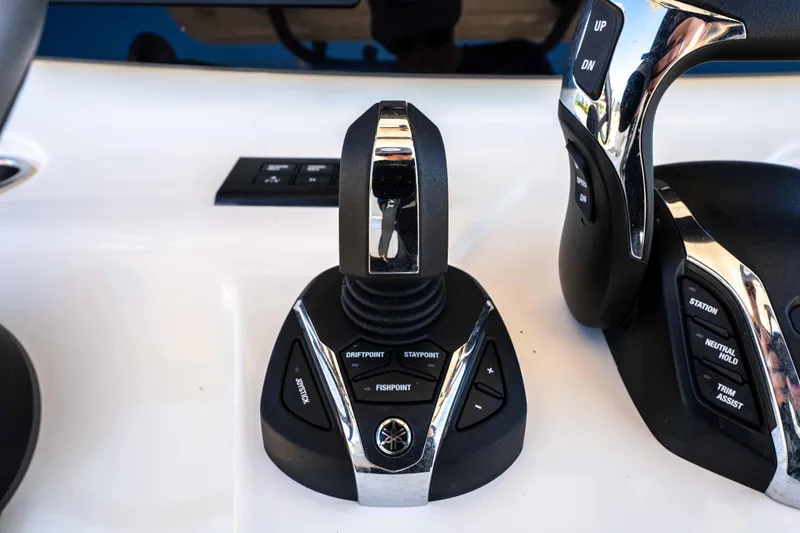 Slide: The Image of 2024 World Cat 260 CC-X boat controls with joystick and buttons for navigation. - 23