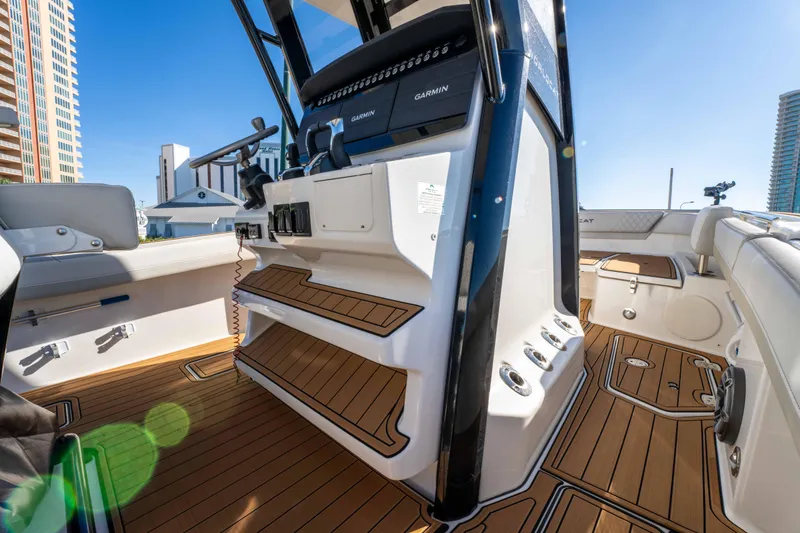 Slide: The Image of 2024 World Cat 260 CC-X boat interior with modern controls and teak flooring. - 27