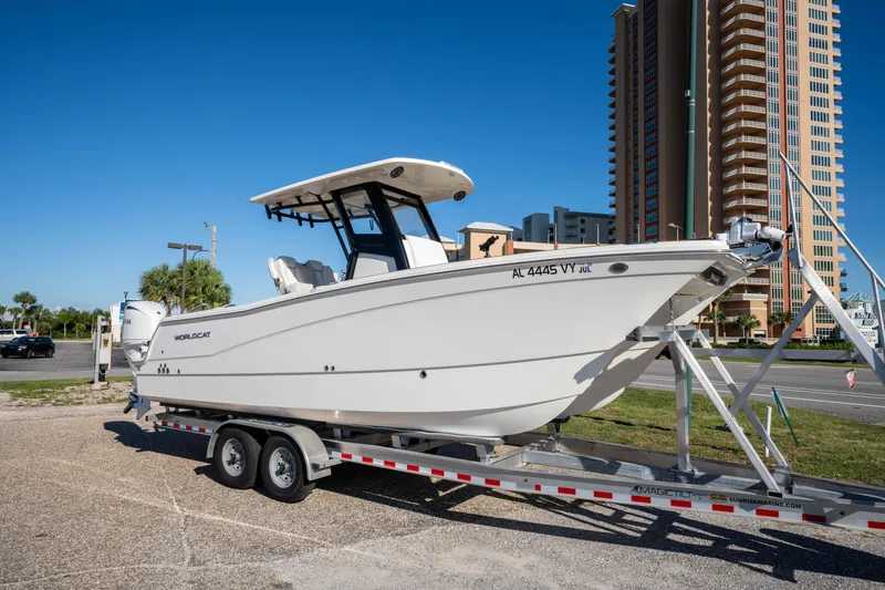 Slide: The Image of 2024 World Cat 260 CC-X boat on trailer, parked near tall buildings. - 3