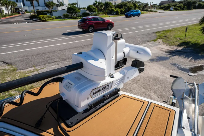 Slide: The Image of Minn Kota trolling motor on 2024 World Cat 260 CC-X boat, parked near a road. - 34
