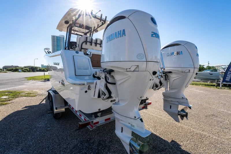 Slide: The Image of 2024 World Cat 260 CC-X boat with dual Yamaha outboard engines, parked on a trailer. - 7