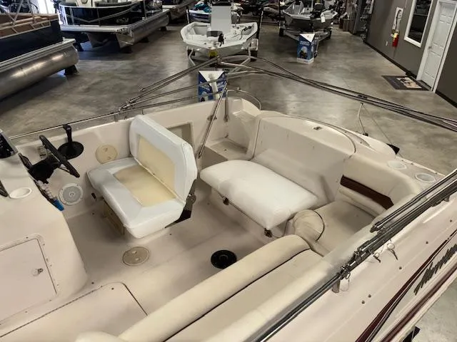 Slide: The Image of 2001 Hurricane Fun Deck GS 201 boat interior with seating and steering wheel in showroom. - 10