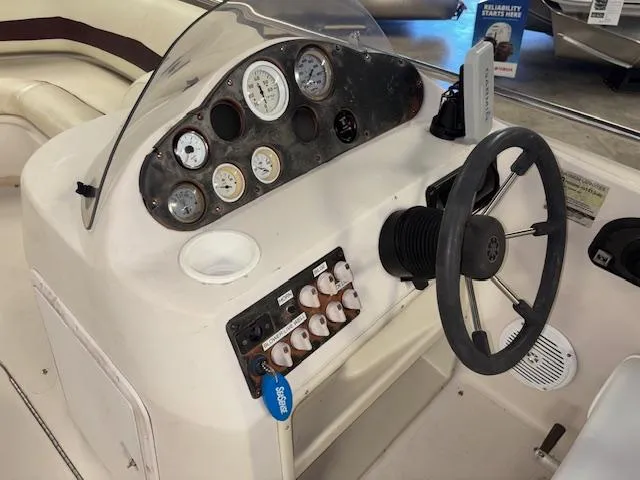 Slide: The Image of 2001 Hurricane Fun Deck GS 201 boat dashboard with steering wheel and gauges. - 13