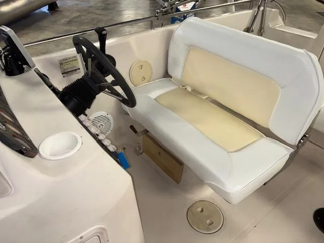 Slide: The Image of 2001 Hurricane Fun Deck GS 201 boat interior with steering wheel and seating. - 14