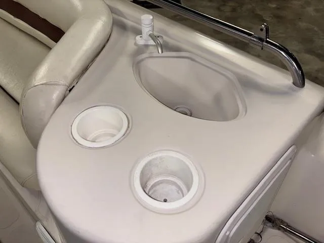 Slide: The Image of 2001 Hurricane Fun Deck GS 201 boat interior with sink and cup holders. - 19