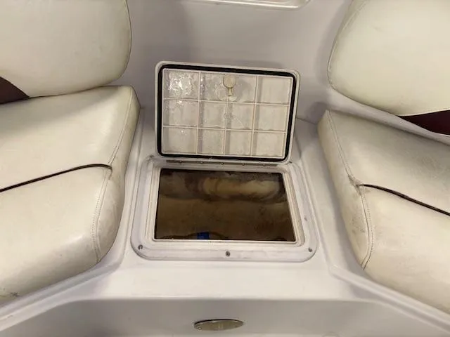 Slide: The Image of 2001 Hurricane Fun Deck GS 201 boat storage compartment with open hatch between seats. - 23