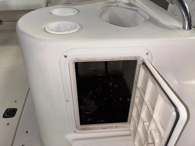 Slide: The Image of 2001 Hurricane Fun Deck GS 201 boat interior with open storage compartment and sink. - 25