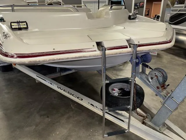 Slide: The Image of 2001 Hurricane Fun Deck GS 201 boat on trailer in indoor storage. - 26
