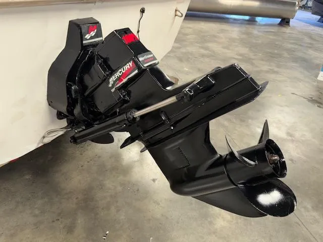 Slide: The Image of Outboard motor of a 2001 Hurricane Fun Deck GS 201 boat in a garage. - 29