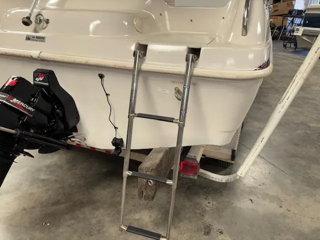 Slide: The Image of 2001 Hurricane Fun Deck GS 201 boat with ladder and Mercury engine in a garage. - 31