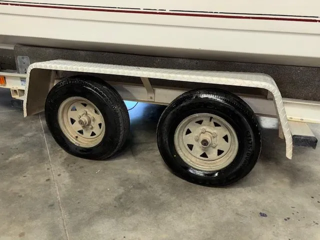 Slide: The Image of Trailer wheels of a 2001 Hurricane Fun Deck GS 201 boat in a garage. - 6