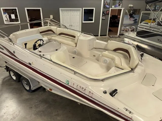 Slide: The Image of 2001 Hurricane Fun Deck GS 201 boat with spacious seating, displayed indoors on a trailer. - 7