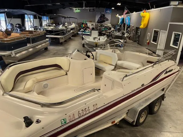 Slide: The Image of 2001 Hurricane Fun Deck GS 201 boat in showroom, surrounded by various other boats. - 8