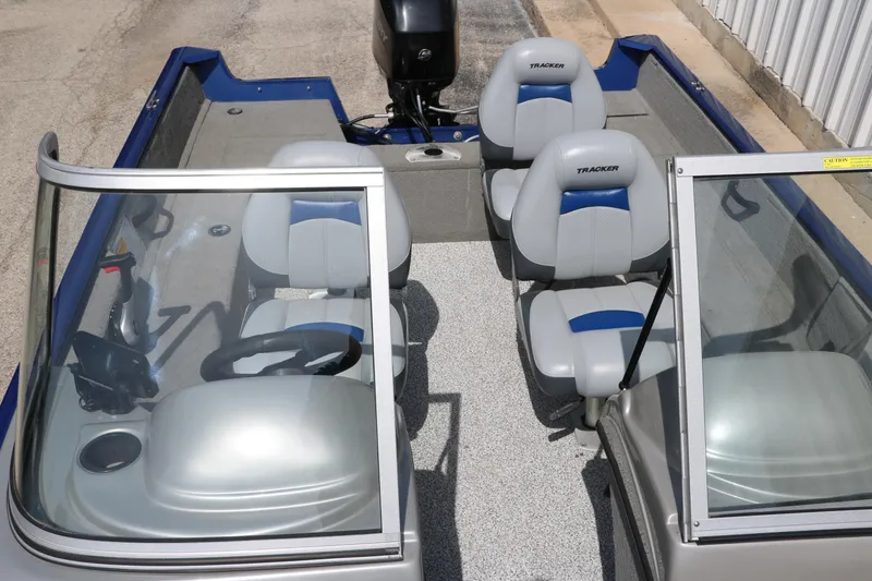 Slide: The Image of 2013 Tracker Pro V16 Guide WT boat interior with seating and steering wheel. - 10