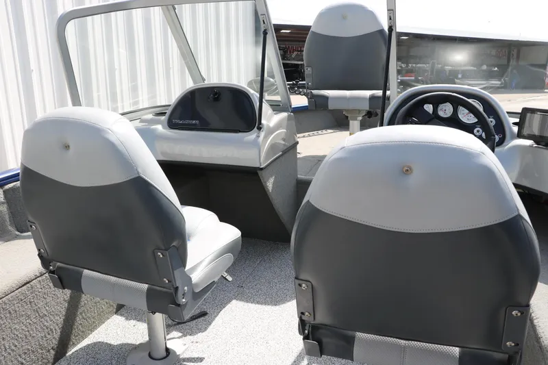 Slide: The Image of 2013 Tracker Pro V16 Guide WT boat interior with gray seating and dashboard. - 14