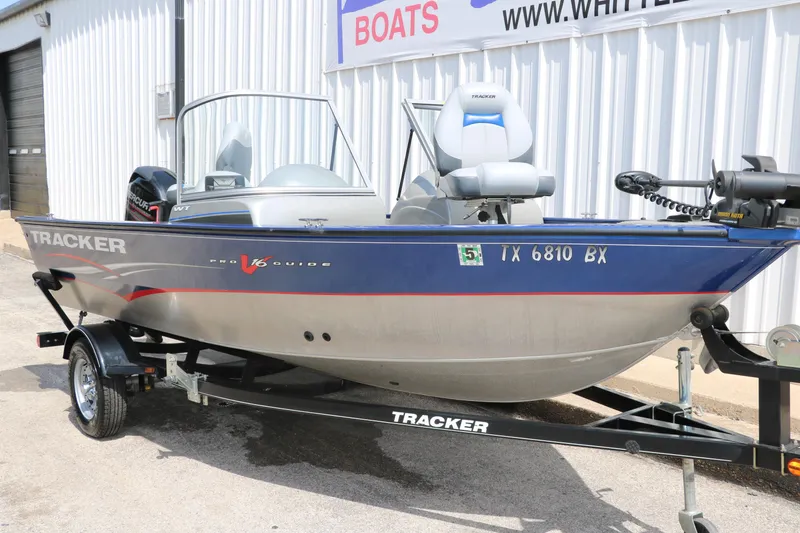Slide: The Image of 2013 Tracker Pro V16 Guide WT boat on trailer, parked outside a building. - 4