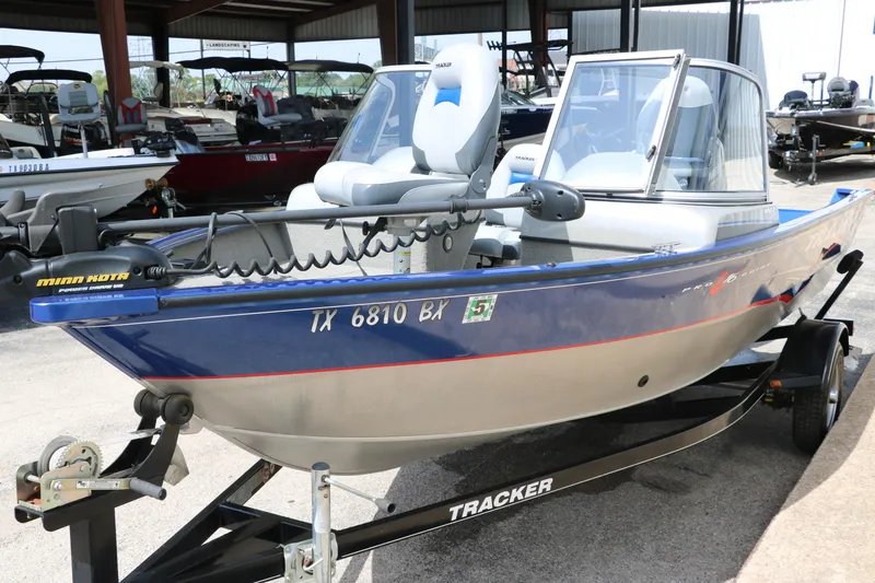 Slide: The Image of 2013 Tracker Pro V16 Guide WT boat on trailer in a showroom. - 5