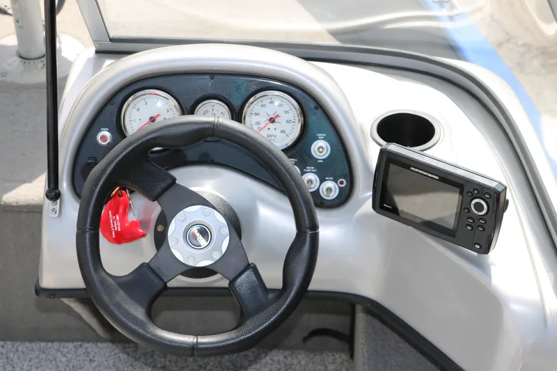 Slide: The Image of 2013 Tracker Pro V16 Guide WT boat dashboard with steering wheel and gauges. - 7