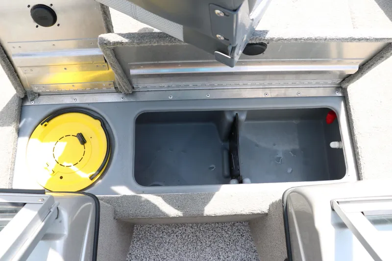 Slide: The Image of 2013 Tracker Pro V16 Guide WT boat storage compartment with yellow lid and gray interior. - 9