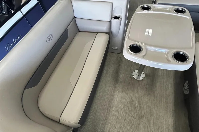 Slide: The Image of 2020 Princecraft Vectra 21 boat interior with beige seating and table with cup holders. - 13