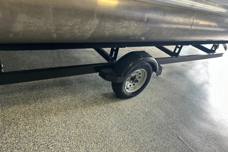 Slide: The Image of Trailer for 2020 Princecraft Vectra 21 pontoon boat on a speckled garage floor. - 21