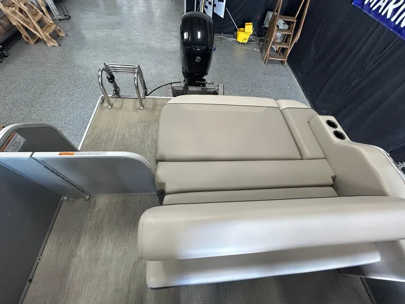 Slide: The Image of 2020 Princecraft Vectra 21 boat interior with beige seating and motor view. - 9