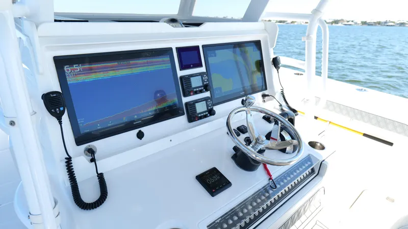 Slide: The Image of Cockpit of 2020 Invincible 37 Catamaran with advanced navigation displays and controls. - 10