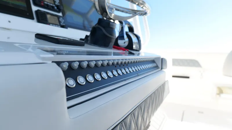 Slide: The Image of Control panel of a 2020 Invincible 37 Catamaran, featuring modern navigation equipment. - 11
