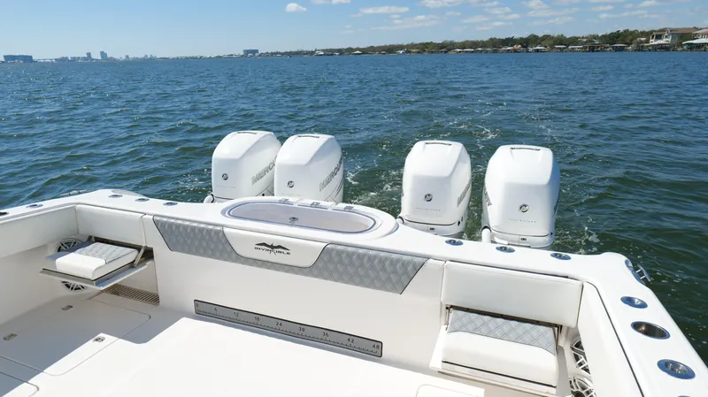 Slide: The Image of 2020 Invincible 37 Catamaran with four outboard engines on open water. - 14