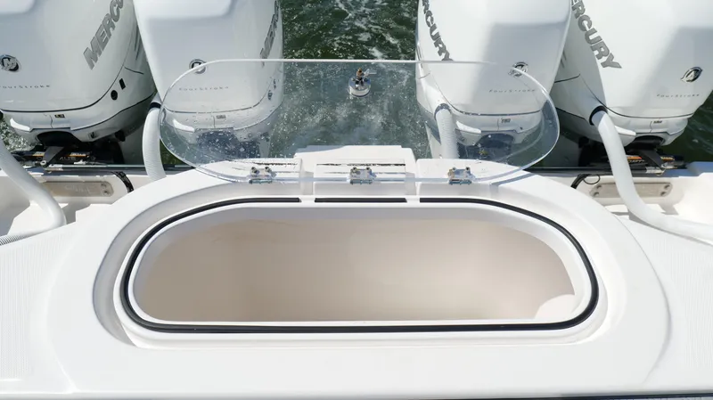 Slide: The Image of 2020 Invincible 37 Catamaran with Mercury outboard engines and open storage compartment. - 17