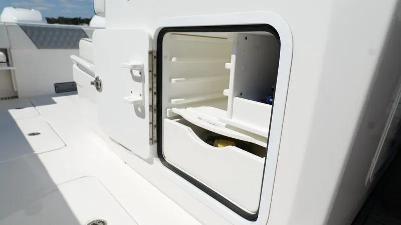 Slide: The Image of Open storage compartment on 2020 Invincible 37 Catamaran, showcasing interior shelving. - 21