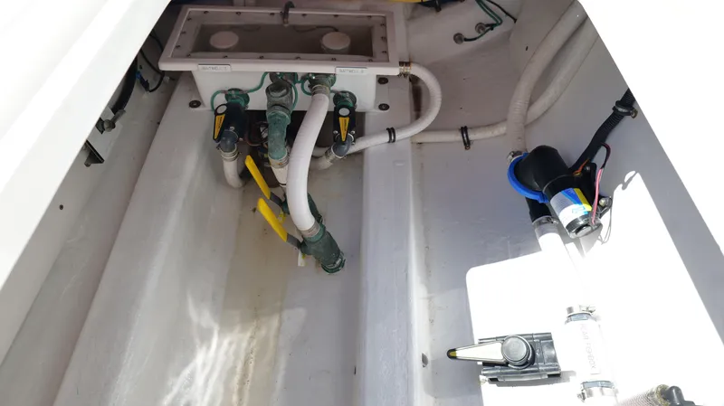 Slide: The Image of Bilge area of 2020 Invincible 37 Catamaran with plumbing and pump components. - 23