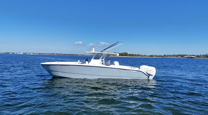 Slide: The Image of 2020 Invincible 37 Catamaran cruising on open water under clear blue sky. - 7