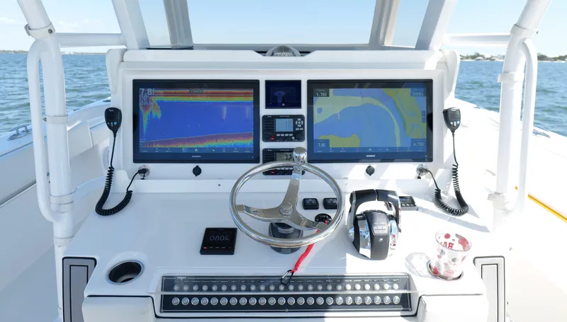 Slide: The Image of Cockpit of 2020 Invincible 37 Catamaran with dual navigation screens and steering wheel. - 9