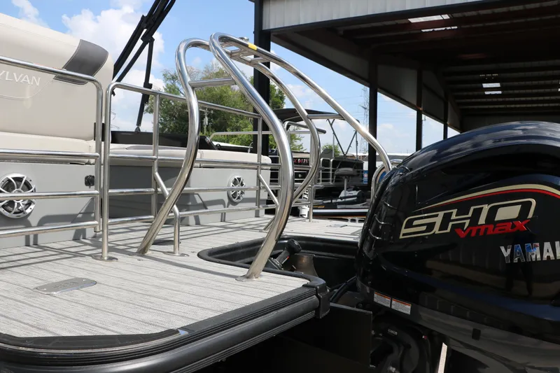 Slide: The Image of 2022 Sylvan L3 RLZ pontoon boat with Yamaha SHO VMAX engine, docked under shelter. - 11