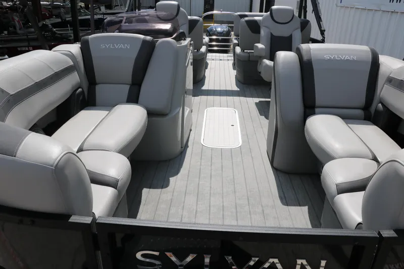 Slide: The Image of 2022 Sylvan L3 RLZ pontoon boat interior with gray seating and spacious layout. - 13