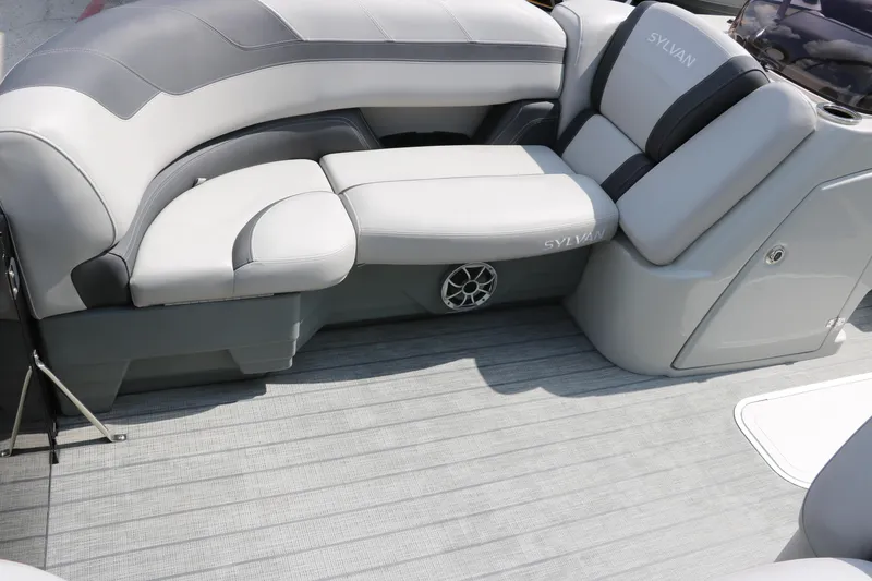 Slide: The Image of 2022 Sylvan L3 RLZ boat interior with gray cushioned seating and speaker. - 17