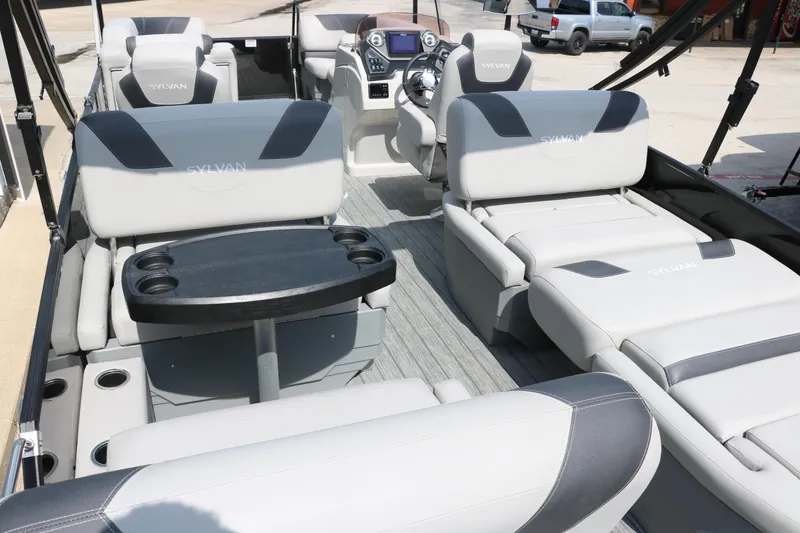 Slide: The Image of 2022 Sylvan L3 RLZ pontoon boat interior with plush seating and modern dashboard. - 22