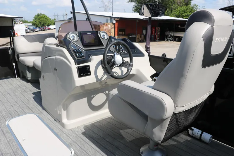 Slide: The Image of 2022 Sylvan L3 RLZ boat interior with steering console and captain's chair. - 28