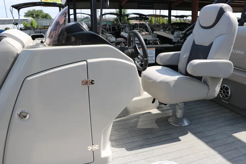 Slide: The Image of Captain's chair and console of 2022 Sylvan L3 RLZ pontoon boat, featuring modern design. - 32