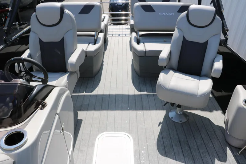 Slide: The Image of 2022 Sylvan L3 RLZ boat interior with plush seating and steering console. - 37