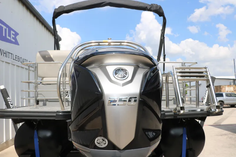 Slide: The Image of 2022 Sylvan L3 RLZ pontoon boat with Yamaha 250 engine, docked under blue sky. - 9