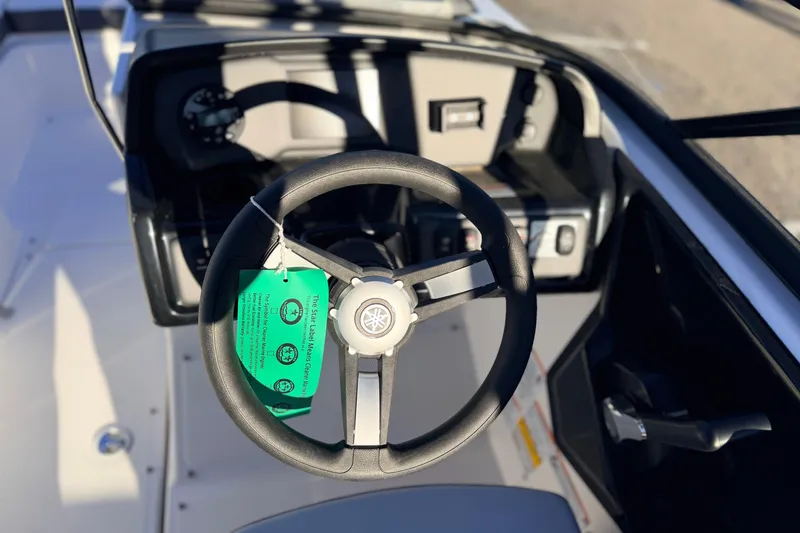 Slide: The Image of Steering wheel of 2025 Yamaha Boats AR190, featuring modern dashboard controls. - 26