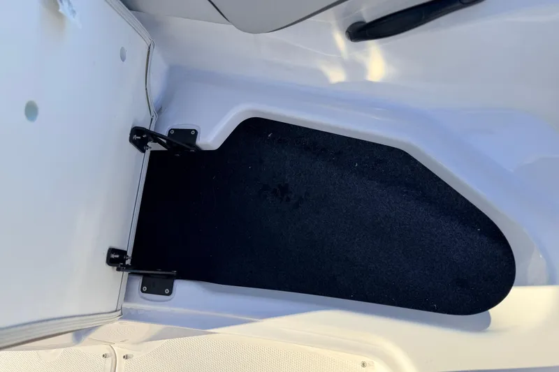 Slide: The Image of 2025 Yamaha Boats AR190 storage compartment with open hatch, showcasing interior space. - 38