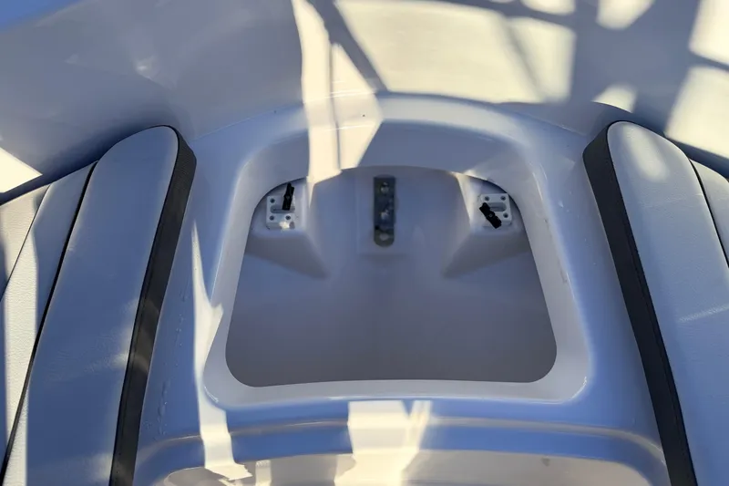 Slide: The Image of 2025 Yamaha Boats AR190 interior seating area with storage compartment. - 40